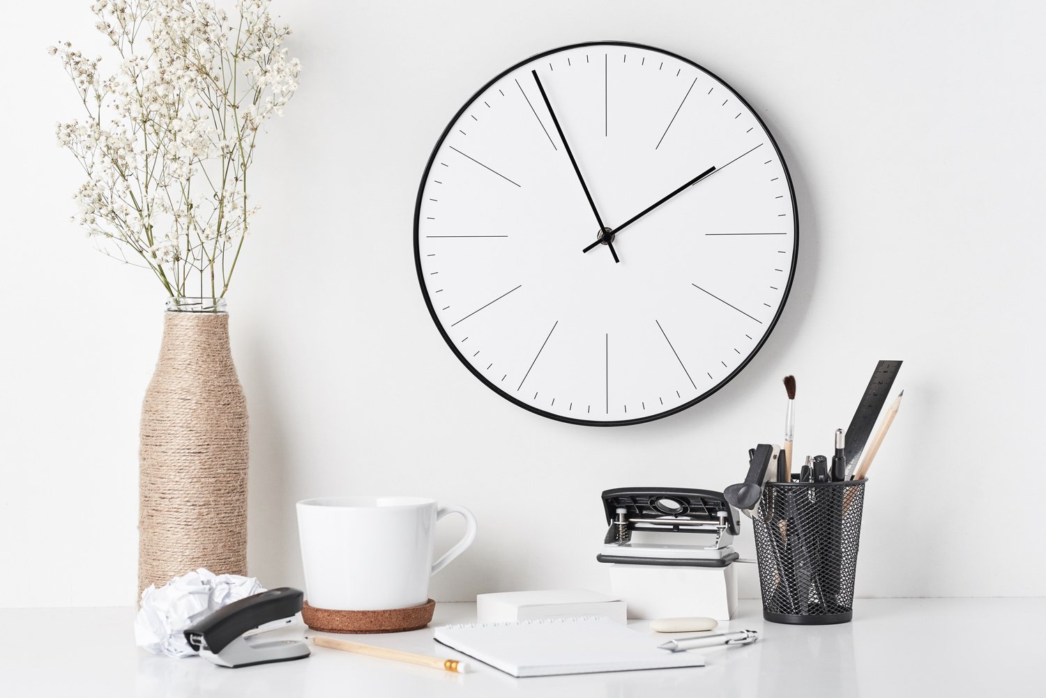 Office Supplies and Wall Clock on White